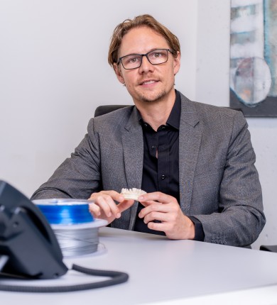 Patrick Burkhalter, COO of smolsys ltd., at his desk