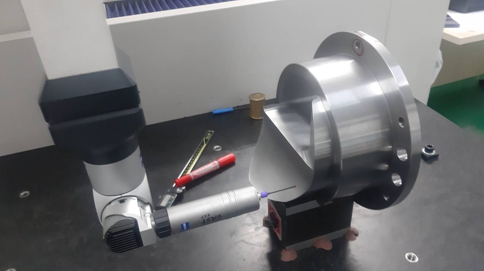 Measuring arm checking a machined flange on the inspection bench